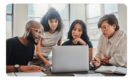 Group of professionals looking at a laptop