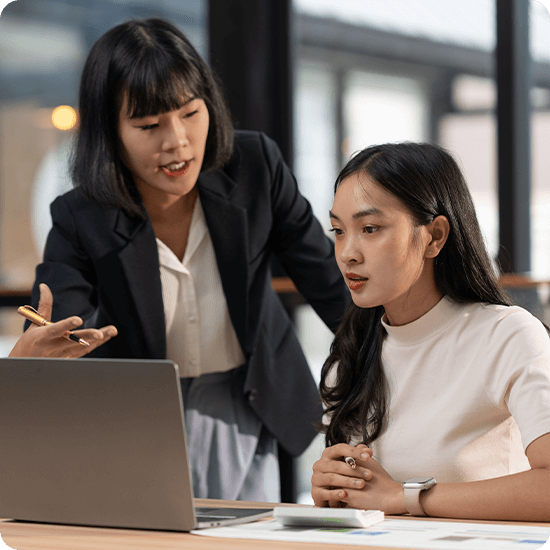 A woman is engaged in conversation with another woman, both appearing attentive and interested in the discussion