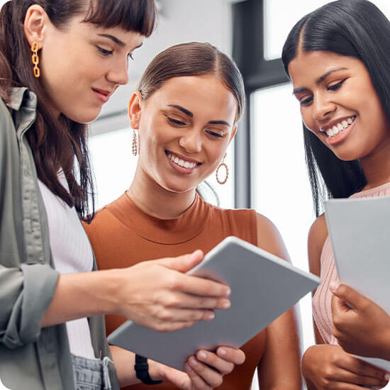 Three women looking at an Ipad