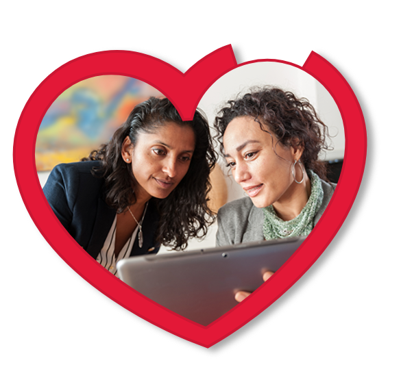 Two people having a conversation while looking at a tablet