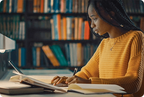 A woman writing on a notebook