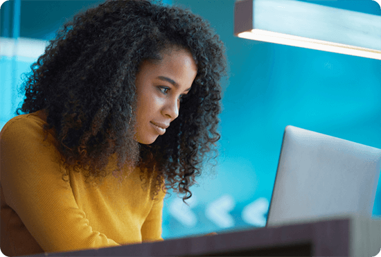 A woman working at a laptop