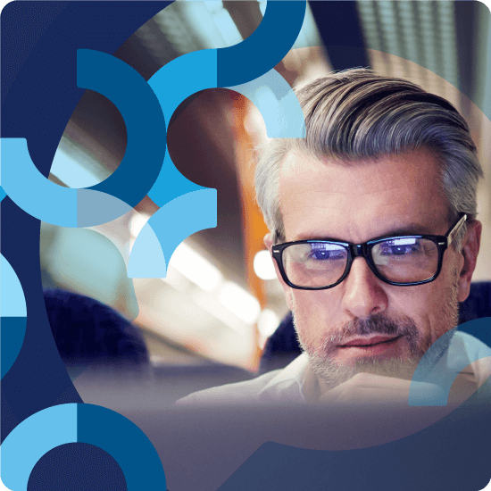 A man with glasses looking at a screen, with blue overlay