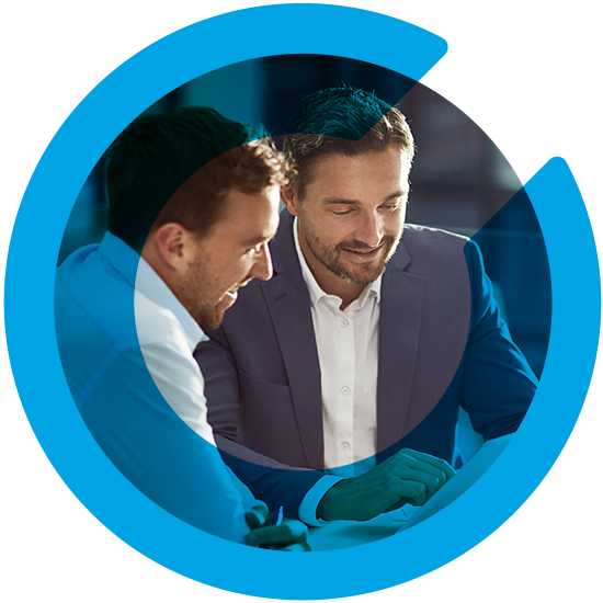 Two men looking over a screen, with a blue C overlay