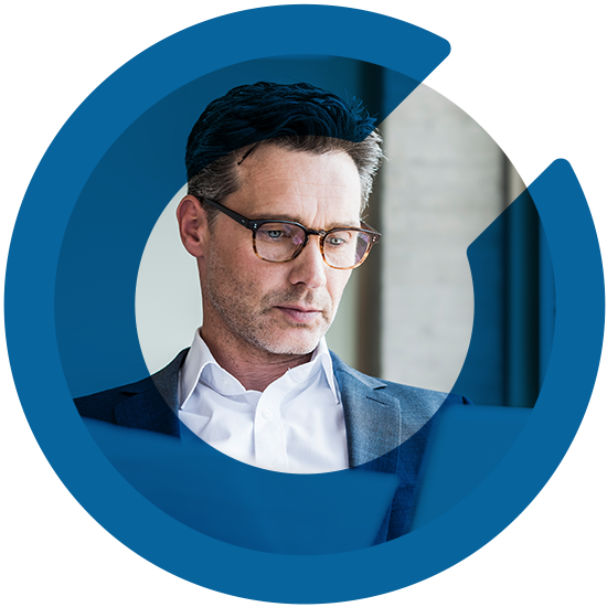 A man looking over some papers, with a blue C overlay