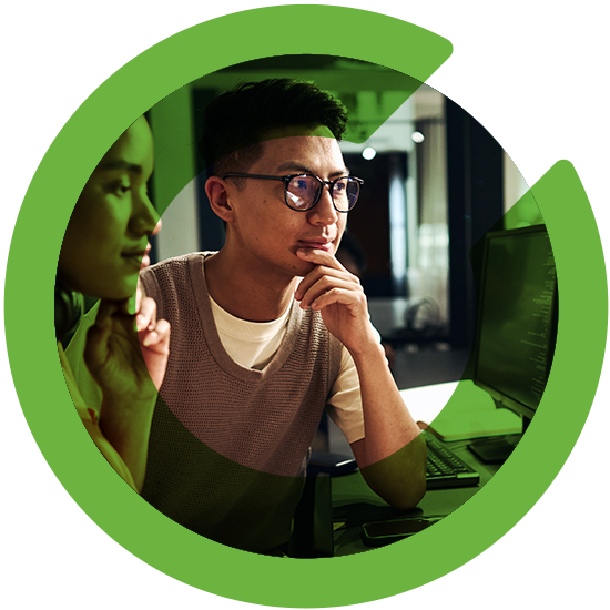 Two people looking over a screen, with a green C overlay