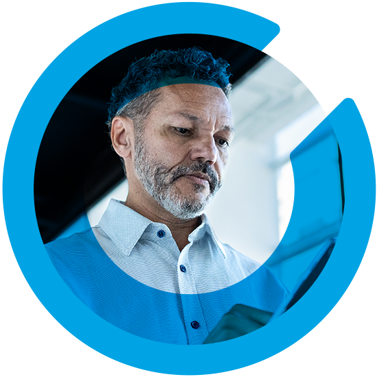 A man looking over a screen, with a blue C overlay