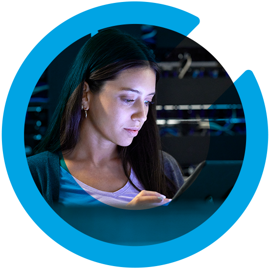 A woman looking over a screen, with a blue C overlay
