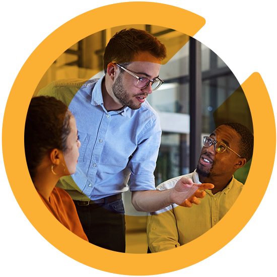 Several people in an office discussing something, with an orange C overlay