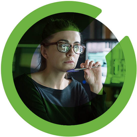 A woman looking over a screen, with a green C overlay