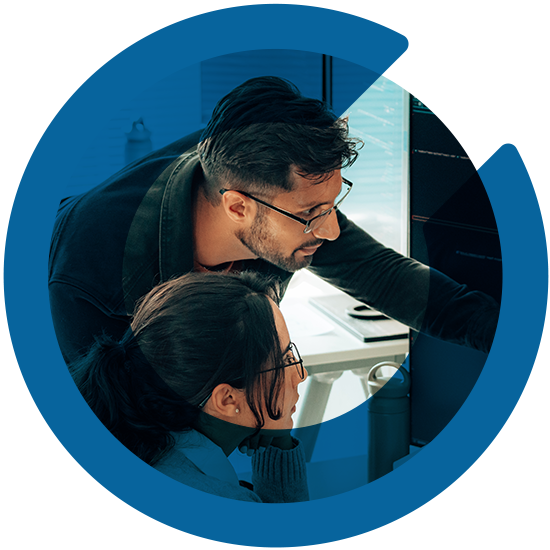 Two people working in front of a computer, with a blue C overlay