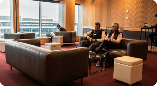A couple people sitting in a lounge