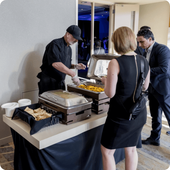 People getting food at a buffet