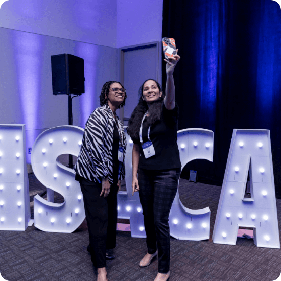 ISACA sign with women taking a selfie