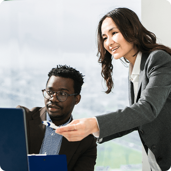 Two colleagues looking at a laptop