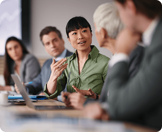 A group of people talking at a desk