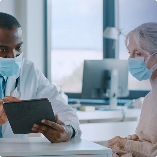 Doctor and patient talking and looking at a tablet