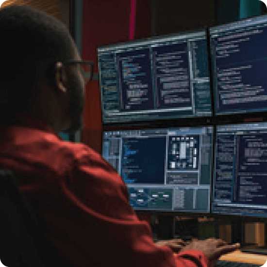 Learning while earning - person working in front of computers