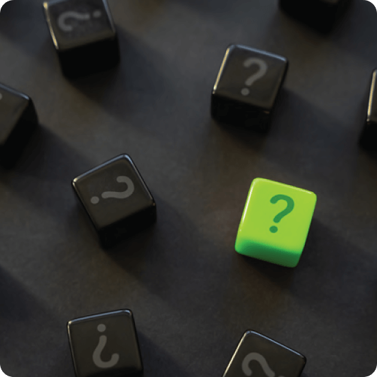 A single green question mark cube stands out among numerous black question mark cubes on a dark surface