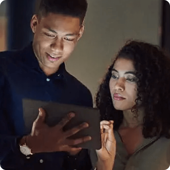 Two people looking at a tablet