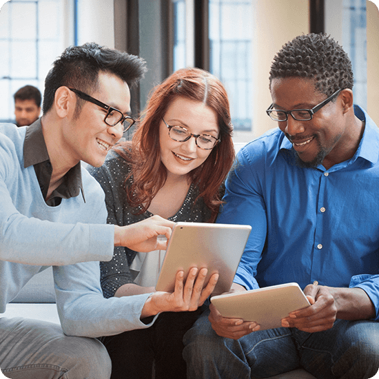 3 students looking at laptops