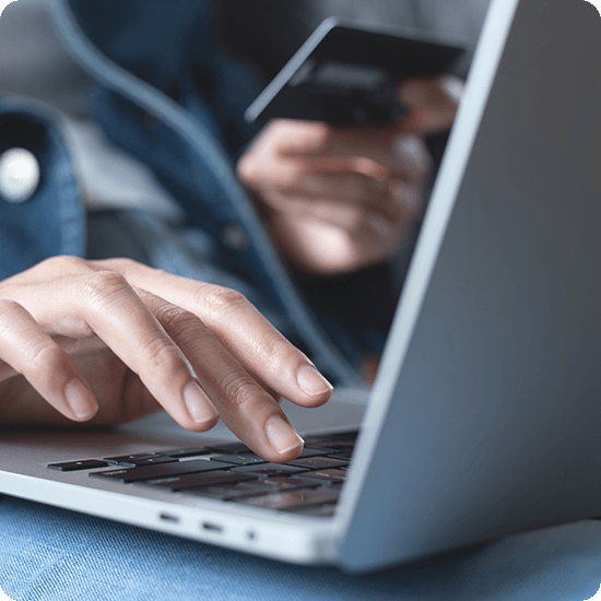 Hand typing on a laptop