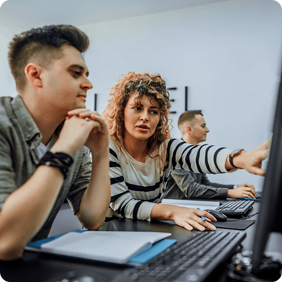 Group of students working at laptops