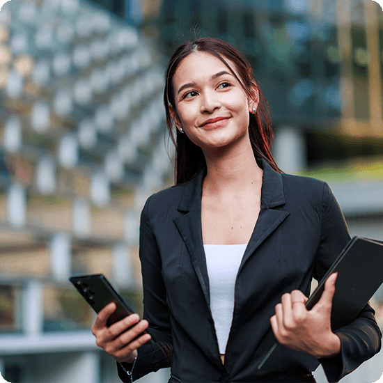 Woman carrying a laptop and phone 