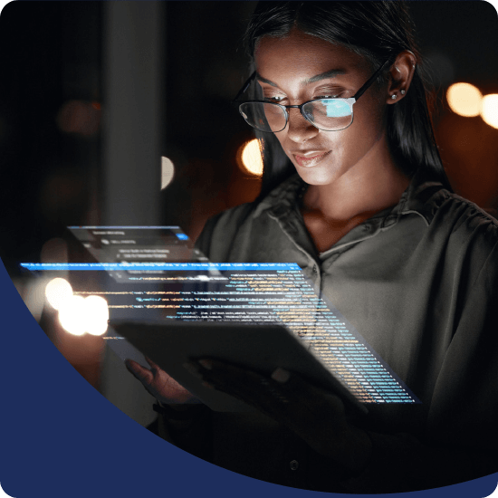 A woman with glasses looking at a tablet