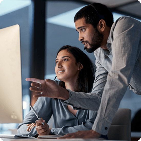 Two people looking at a monitor