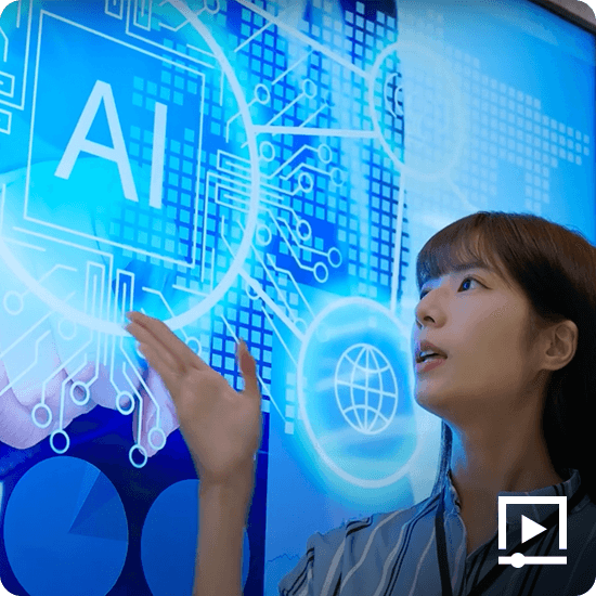 A woman with her hand underneath a digital board with the letter AI